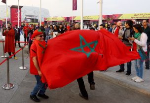 Soccer Football - FIFA World Cup Qatar 2022 - Quarter Final - Morocco v Portugal - Al Thumama Stadium, Doha, Qatar - December 10, 2022 Morocco fans are pictured with the flag of Morocco outside the stadium before the match REUTERS/Ibraheem Al Omari