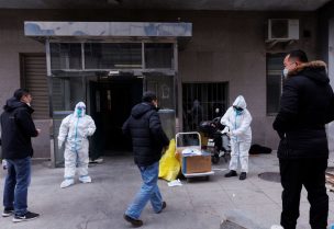Pandemic prevention workers in protective suits get ready to enter an apartment building that went into lockdown as coronavirus disease (COVID-19) outbreaks continue in Beijing, December 2, 2022. REUTERS/Thomas Peter