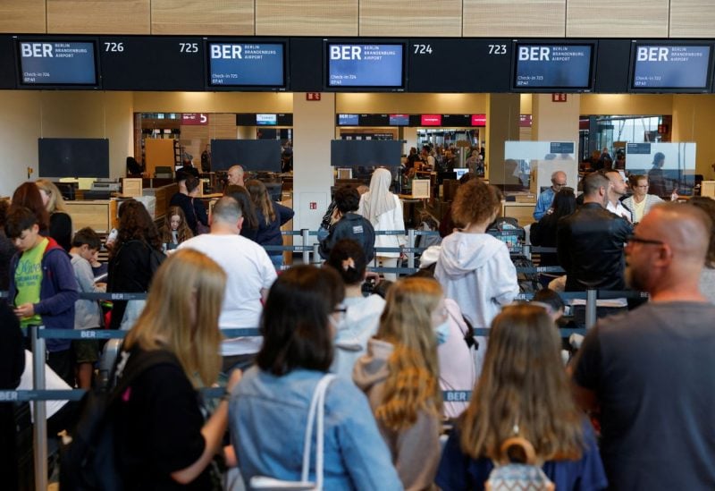 Passengers wait in line at Berlin Brandenburg Airport (BER), in Schoenefeld near Berlin, Germany, July 7, 2022. REUTERS/Michele Tantussi