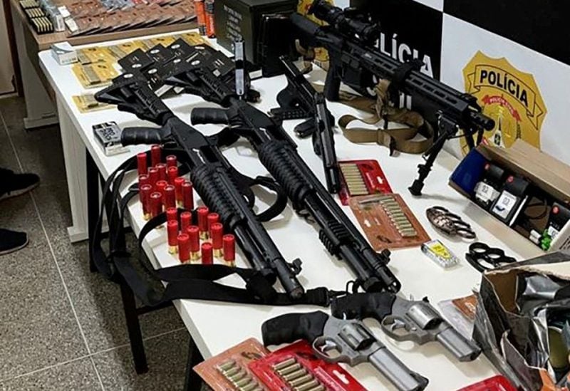 Weapons confiscated from George Washington de Oliveira Sousa, detained the day after police said they thwarted his plan to detonate an explosive device near Brasilia airport, are seen on display, in this undated handout photo, in Brasilia, Brazil. Delegacia-Geral da Policia Civil do Distrito Federal/Handout via REUTERS/File Photo