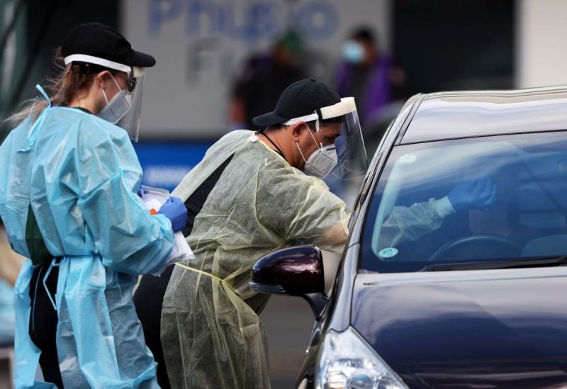 A medical worker administers a COVID-19 test at a testing clinic during a lockdown to curb the spread of a coronavirus disease (COVID-19) outbreak in Auckland, New Zealand, August 26, 2021. REUTERS/Fiona Goodall