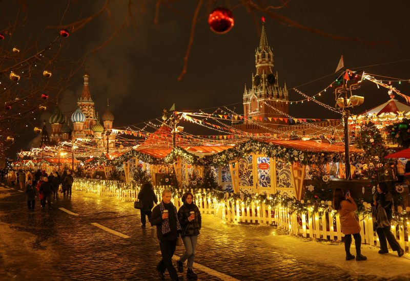 People walk past a Christmas market in Red Square in Moscow, Russia December 26, 2022. REUTERS