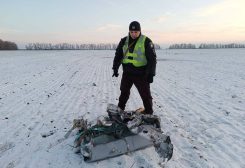 A police officer stands next to a part of a Russian cruise missile shot down by the Ukrainian Air Defense Forces, amid Russia's attack on Ukraine, in Kyiv region, Ukraine December 5, 2022 - REUTERS