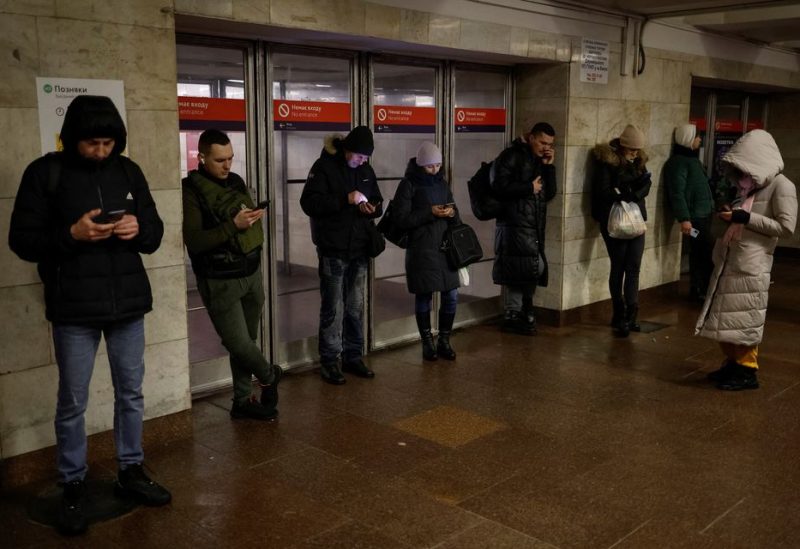 People use mobile internet next to a metro station after critical civil infrastructure was hit by Russian missile attacks, amid Russia's invasion of Ukraine, in Kyiv, Ukraine December 16, 2022. REUTERS/Valentyn Ogirenko