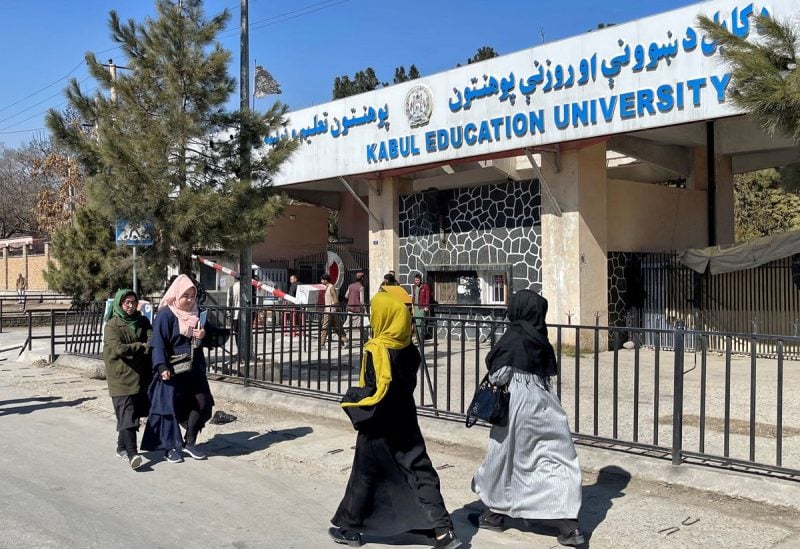 Female students walk in front of the Kabul Education University in Kabul, Afghanistan, February 26, 2022. REUTERS/Stringer
