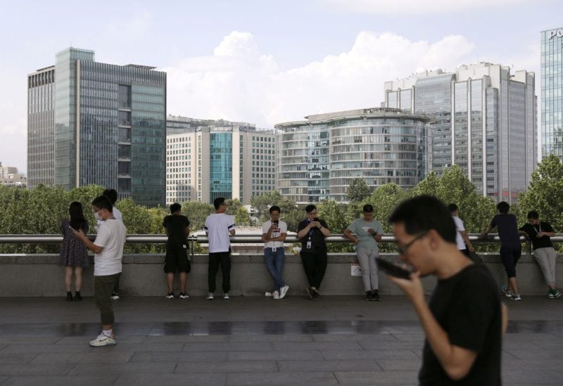 People are seen at Beijing's tech hub Zhongguancun, China August 23, 2021. REUTERS/Tingshu Wang