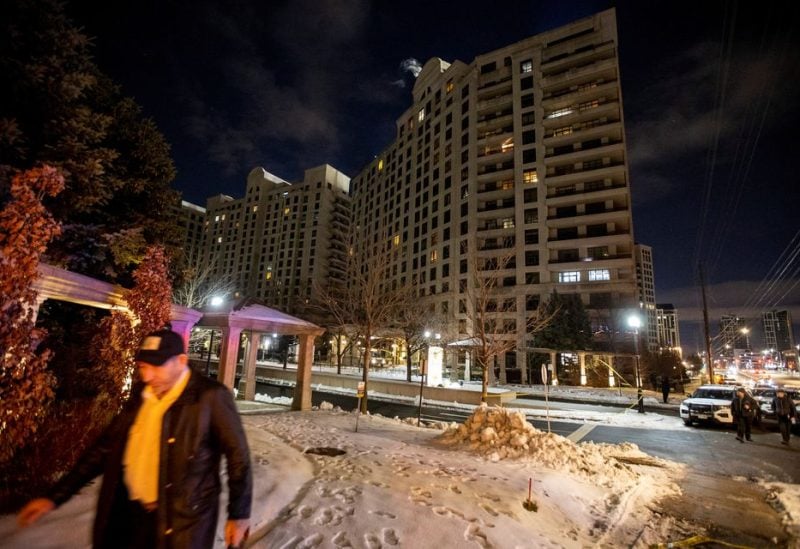 A person walks past the scene after a fatal mass shooting at a condominium building in the Toronto suburb of Vaughan, Ontario, Canada December 19, 2022. REUTERS