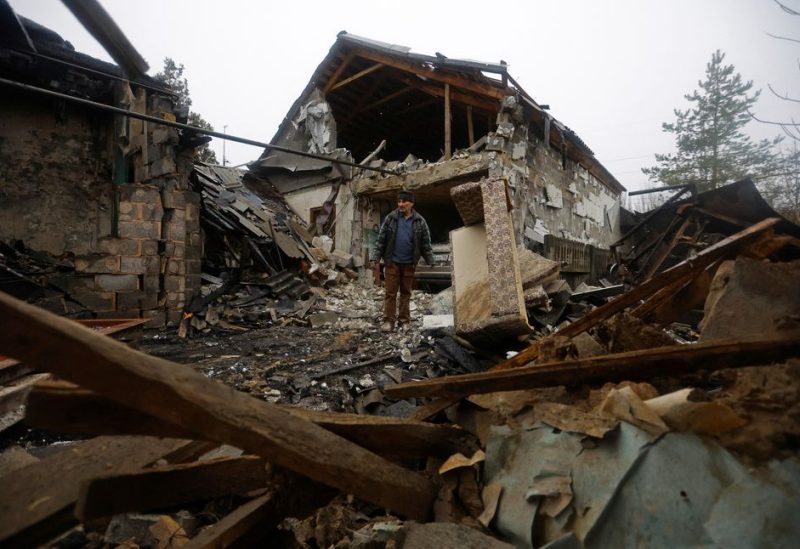 Local resident Amiram stands next to his friend's house destroyed by recent shelling in the course of Russia-Ukraine conflict in Donetsk, Russian-controlled Ukraine, December 17, 2022. REUTERS/Alexander Ermochenko
