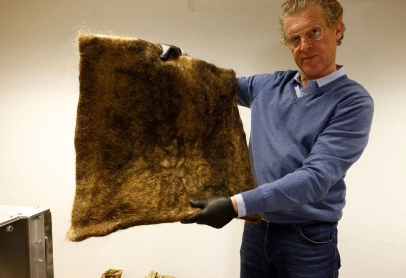 Patrick Janssen, co-founder of the organisation Dung Dung, shows a tile made from recycled human hair that is used to absorb polluting chemical substances in water, in Waremme, Belgium December 8, 2022. REUTERS/Yves Herman