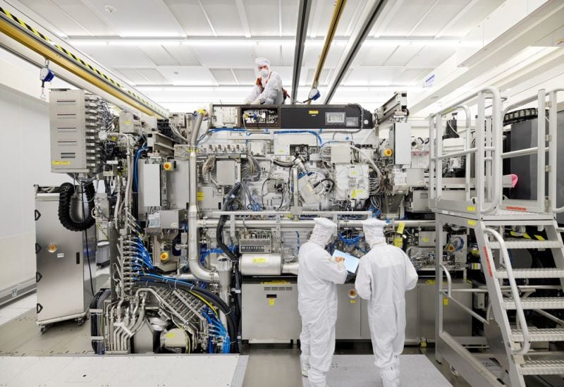 Employees are seen working on the final assembly of ASML's TWINSCAN NXE:3400B semiconductor lithography tool with its panels removed, in Veldhoven, Netherlands, in this picture taken April 4, 2019. Bart van Overbeeke Fotografie/ASML/Handout via REUTERS/File Photo