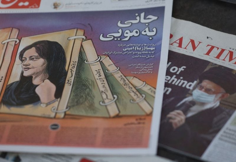 A newspaper with a cover picture of Mahsa Amini, a woman who died after being arrested by the Islamic republic's "morality police" is seen in Tehran, Iran September 18, 2022. Majid Asgaripour/WANA (West Asia News Agency) via REUTERS/File Photo
