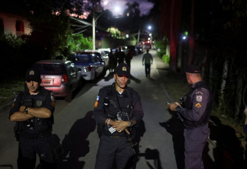 Police officers block a street as supporters of Brazilian politician Roberto Jefferson, who fired at police while resisting arrest ordered by the country's Supreme Court, demonstrate close to his house in Comendador Levy Gasparian, Rio de Janeiro state, Brazil, October 23, 2022. REUTERS/Ricardo Moraes