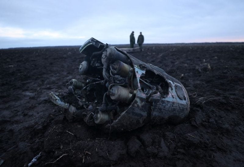 Investigators gather near fragments of a munition, what Belarus' defense ministry said were parts of a Ukrainian S-300 missile downed by Belarusian air defenses outside the village of Harbacha in the Grodno region, Belarus, December 29, 2022 -REUTERS