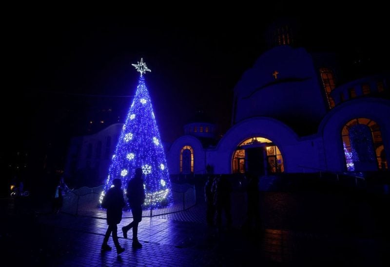 A Christmas tree is seen in front of an Orthodox cathedral during a service on the eve of Christmas, amid Russia’s attack on Ukraine continues, in Kyiv, Ukraine December 24, 2022. REUTERS/Valentyn Ogiren