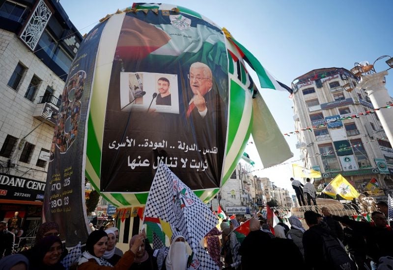 Palestinians attend a rally marking the 58th anniversary of Fatah movement foundation, in Ramallah, in the Israeli-occupied West Bank, December 29, 2022. REUTERS/Mohamad Torokman