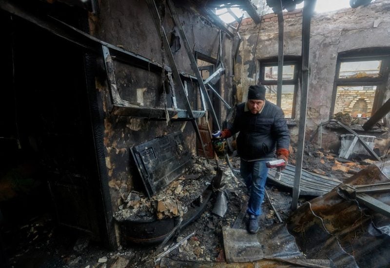 Local resident Pavel gathers belongings of his neighbour, who was killed in recent shelling, in his neighbour's house destroyed in the course of Russia-Ukraine conflict in Donetsk, Russian-controlled Ukraine, December 10, 2022. REUTERS/Alexander Ermochenko TPX IMAGES OF THE DAY