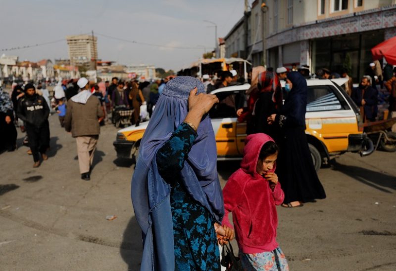 An Afghan woman and a girl walk in a street in Kabul, Afghanistan, November 9, 2022. REUTERS/Ali Khara