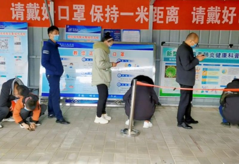 People wait in line at a coronavirus disease (COVID-19) test centre in Xinyang, China, this still image obtained from social media video released December 15, 2022. Video obtained by REUTERS