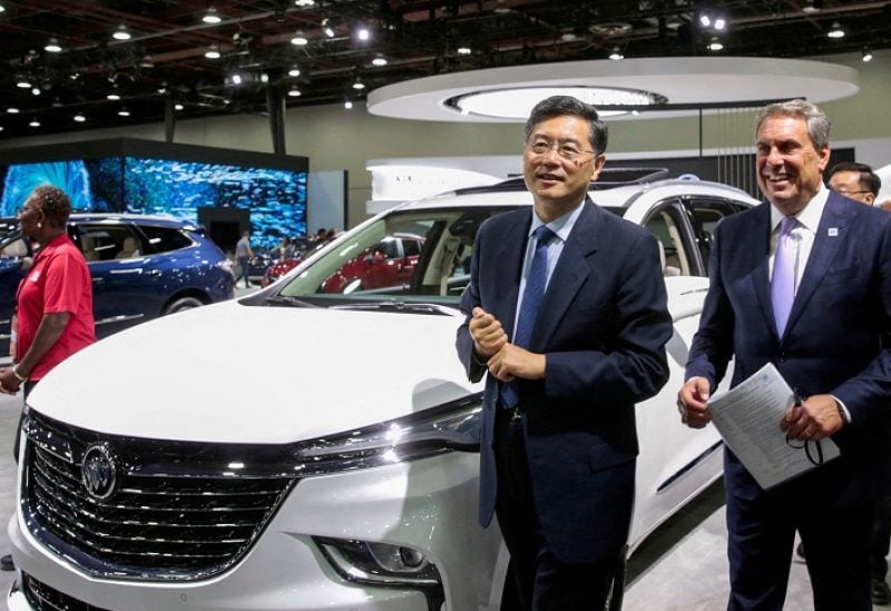 FILE PHOTO: General Motors President Mark Reuss (R) and Chinese Ambassador to the U.S Qin Gang walk together during a media day of the North American International Auto Show in Detroit, Michigan, U.S. September 14, 2022. REUTERS/Rebecca Cook/File Photo