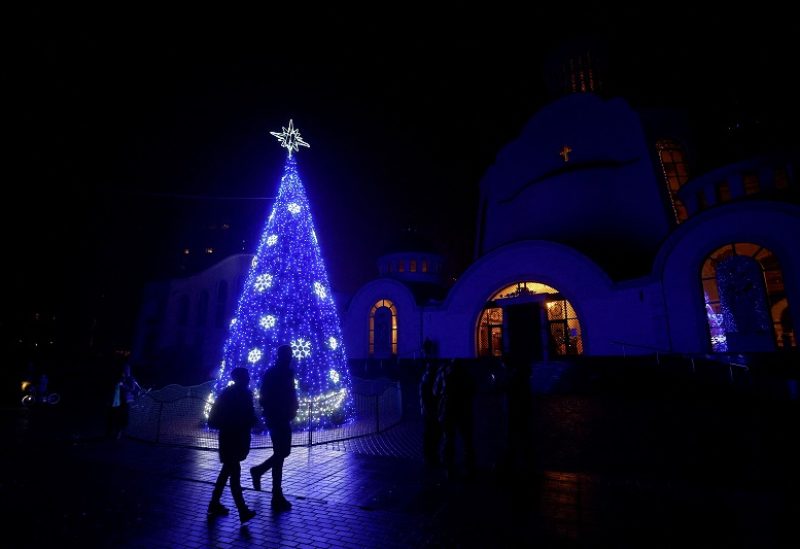 A Christmas tree is seen in front of an Orthodox cathedral during a service on the eve of Christmas, amid Russia’s attack on Ukraine continues, in Kyiv, Ukraine December 24, 2022. REUTERS/Valentyn Ogirenko TPX IMAGES OF THE DAY