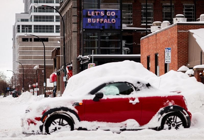 A "let’s go Buffalo" sign is seen behind an abandoned car on the road following a winter storm in Buffalo, New York, U.S., December 27, 2022. REUTERS/Lindsay DeDario TPX IMAGES OF THE DAY