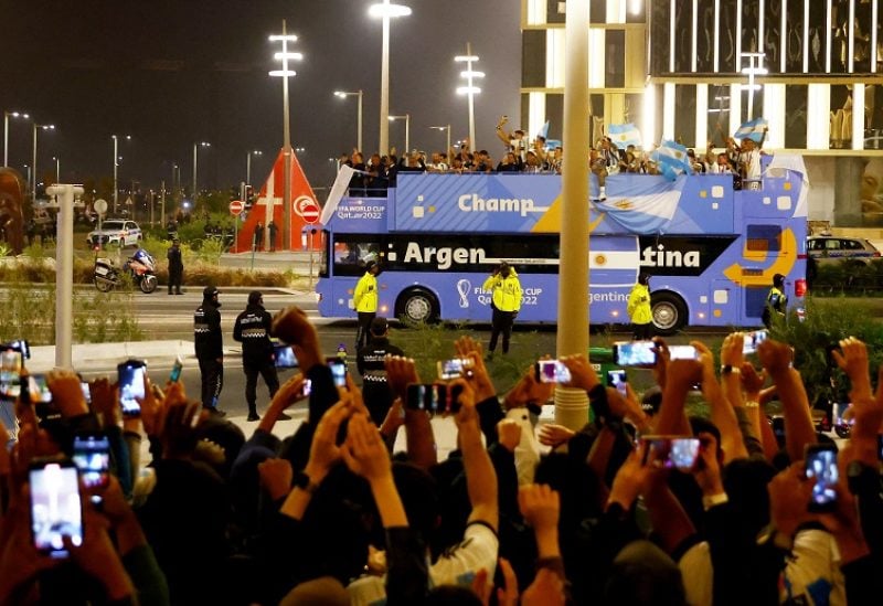 Soccer Football - FIFA World Cup Qatar 2022 - Final - Argentina v France - Lusail Stadium, Lusail, Qatar - December 19, 2022 Argentina players celebrate with the trophy on a bus outside the stadium after winning the World Cup REUTERS/Hannah Mckay