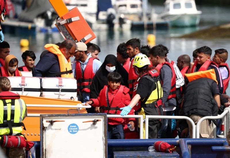 Migrants arrive at Dover harbour on board a Border Force vessel, after being rescued while attempting to cross the English Channel, in Dover, Britain, August 24, 2022. REUTERS