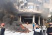 Smoke rises near a building as people take part in a protest in Sweida, Syria, December 4, 2022, in this picture obtained by Reuters. Suwayda 24/via REUTERS