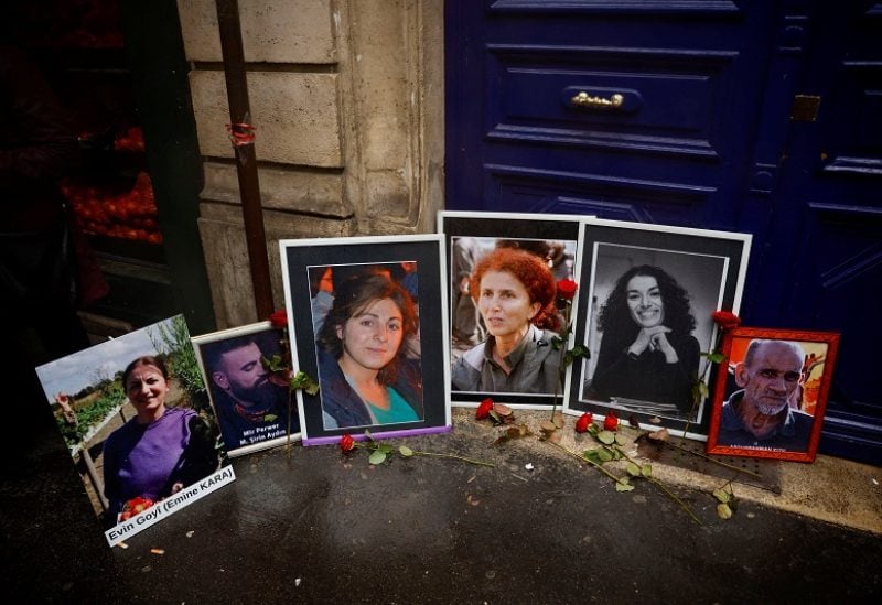 Portraits of six victims who were killed in attacks in 2013 and 2022 are seen as members of the Kurdish community hold a march organised by the Kurdish Democratic Council in France (CDK-F) in tribute to the victims of Friday's deadly attack, in Paris, France, December 26, 2022. REUTERS/Sarah Meyssonnier