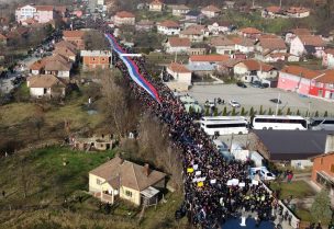 Local Serbs carry a giant Serbian flag as they protest against the government near a roadblock in Rudare, near the northern part of the ethnically-divided town of Mitrovica, Kosovo, December 22, 2022. REUTERS/Fatos Bytyci