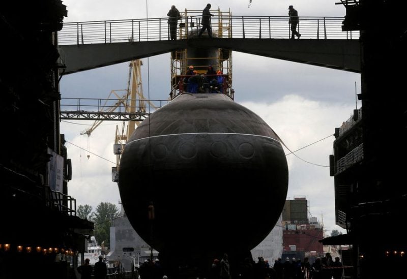 People attend a ceremony launching the diesel-electric submarine "Rostov-on-Don" at the Admiralty Shipyards in St. Petersburg, June 26, 2014. REUTERS