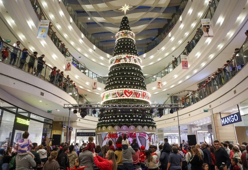 People gather near a Christmas tree inside a shopping mall during holiday season in Hazmieh, Lebanon December 22, 2022. REUTERS/Mohamed Azakir