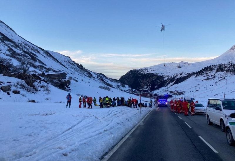 Rescue workers stand near the site where an avalanche buried 10 skiers in the Lech/Zuers free skiing area on Arlberg, Austria, December 25, 2022. Police Vorarlberg/Handout via REUTERS