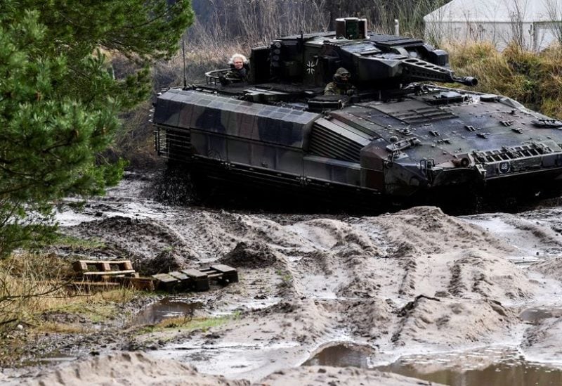 German Defence Minister Christine Lambrecht sits in a Puma fighting tank during her visit at Munster military base, in Munster, Germany, February 7, 2022. REUTERS