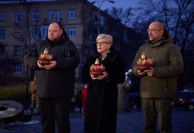 Lithuanian Prime Minister Ingrida Simonyte, Ukrainian Prime Minister Denys Shmyhal and Parliament Speaker Ruslan Stefanchuk visit a monument to Holodomor victims during a commemoration ceremony of the famine of 1932-33, in which millions died of hunger, amid Russia's attack on Ukraine, in Kyiv, Ukraine November 26, 2022. Ukrainian Presidential Press Service/Handout via REUTERS ATTENTION EDITORS - THIS IMAGE HAS BEEN SUPPLIED BY A THIRD PARTY.