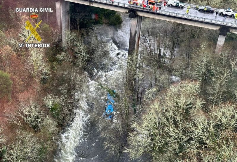 Emergency services work at the scene of an accident where a passenger bus plunged off a bridge into the river Lerez in Cerdedo-Cotobade, northwestern Spain, December 25, 2022. GUARDIA CIVIL/Handout via REUTERS