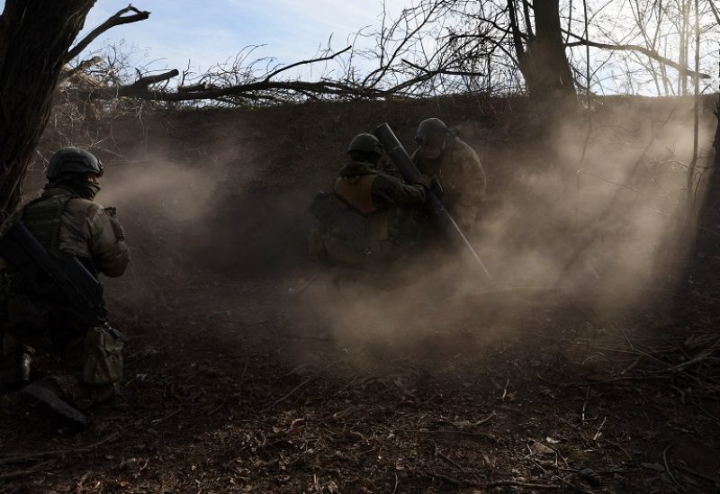 Service members with the Freedom of Russia Legion under the Ukrainian Army prepare to fire a mortar at a Russian military position, as Russia's invasion of Ukraine continues, near Bakhmut, Ukraine, December 2, 2022. REUTERS/Leah Millis