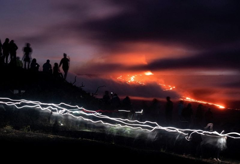 People gather to observe the eruption of the Mauna Loa Volcano in Hawaii, U.S. December 1, 2022. REUTERS/Go Nakamura TPX IMAGES OF THE DAY