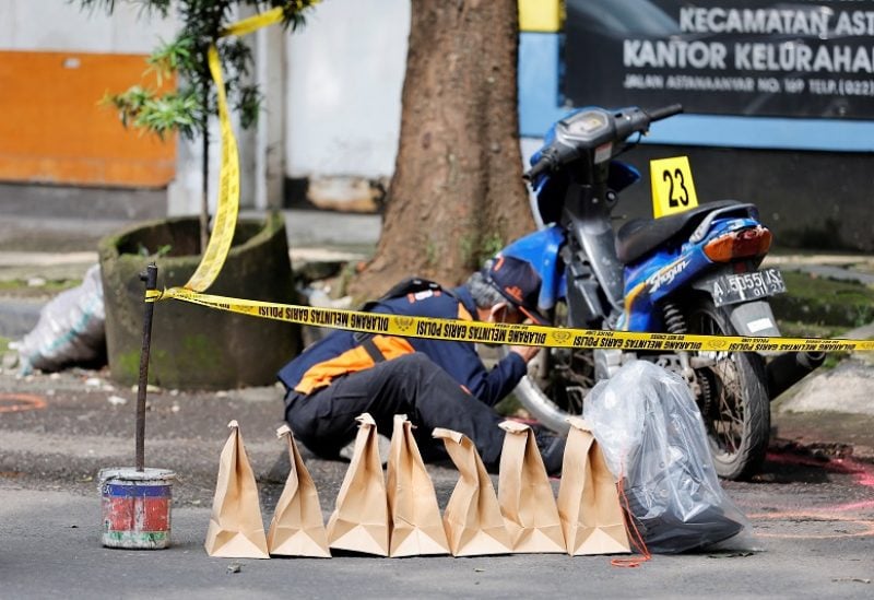 An Indonesia Automatic Fingerprint Identification System (INAFIS) officer collects evidence following a blast at a district police station, that according to authorities was a suspected suicide bombing, in Bandung, West Java province, Indonesia, December 7, 2022. REUTERS/Willy Kurniawan