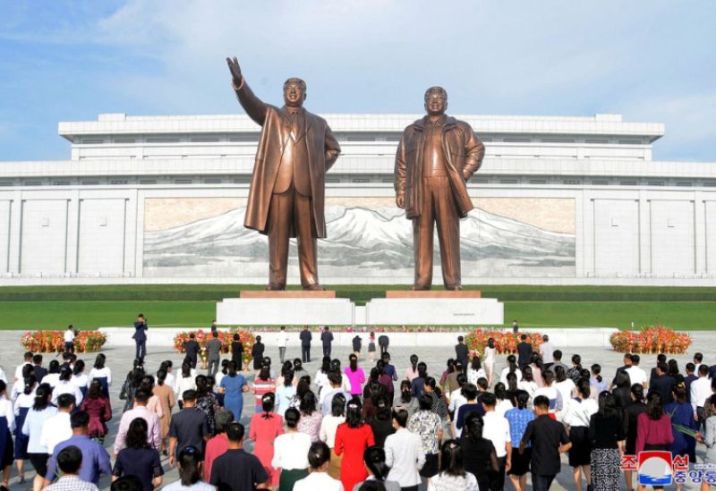People visit the the statues of North Korea's founder Kim Il Sung and late leader Kim Jong Il on the 74th anniversary of North Korea's founding, in Pyongyang, North Korea in this photo released by North Korea's Korean Central News Agency (KCNA) September 10, 2022. KCNA via REUTERS