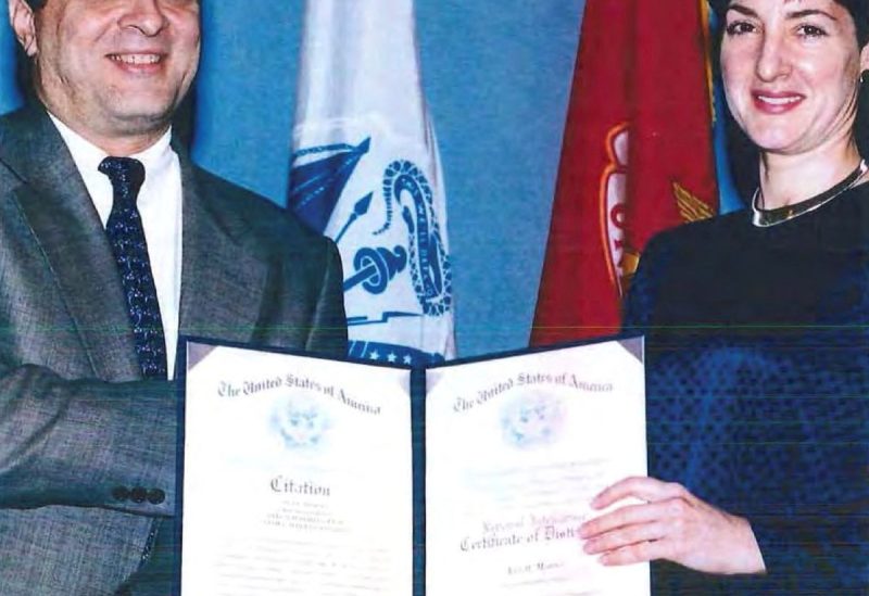 An undated handout image from a U.S. Department of Defense report dating back to 2005 shows Ana Belen Montes receiving a national intelligence certificate of distinction from George Tenet, who served as Director of Central Intelligence (DCI) for the United States Central Intelligence Agency. U.S. Department of Defense/Handout via REUTERS
