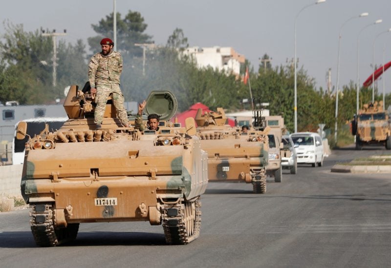 Members of Syrian National Army, known as Free Syrian Army, drive in an armored vehicle in the Turkish border town of Ceylanpinar in Sanliurfa province, Turkey, October 11, 2019. REUTERS/Murad Sezer