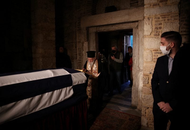 A Greek Orthodox priest pays his respects to former King of Greece Constantine II at Saint Eleftherios chapel, where he lies at rest before the funeral service, in Athens, Greece, January 16, 2023. REUTERS/Alkis Konstantinidis