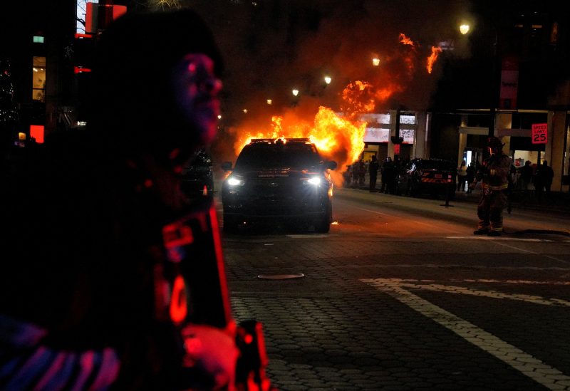 A law enforcement vehicle is seen lit on fire during demonstrations related to the death of Manuel Teran who was killed during a police raid inside Weelaunee People's Park, the planned site of a controversial "Cop City" project, in Atlanta, Georgia, U.S., January 21, 2023. REUTERS/Cheney Orr