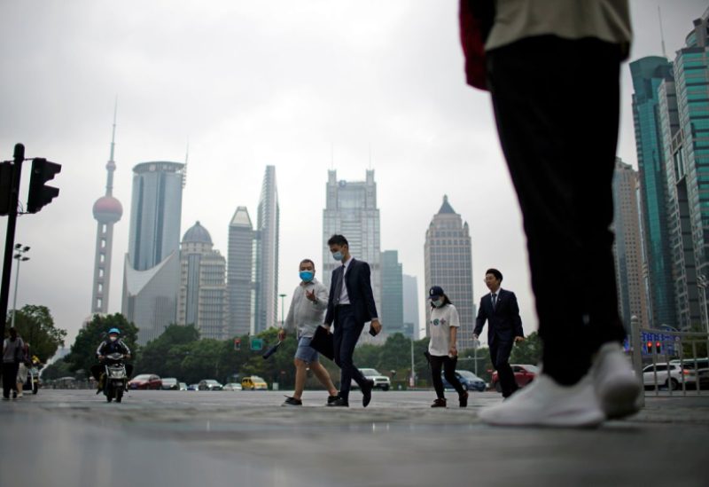 People walk along at financial district of Lujiazui in Shanghai, China October 15, 2021. REUTERS/Aly Song/File Photo