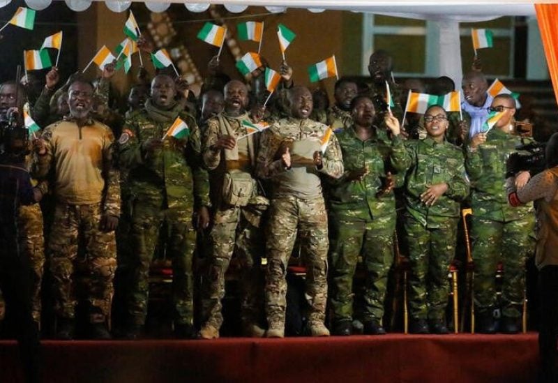 Members of the forty-six Ivorian soldiers recently pardoned by Mali's junta, celebrate during their arrival at the international Felix Houphouet Boigny airport in Abidjan, Ivory Coast January 8, 2023. REUTERS/Luc Gnago