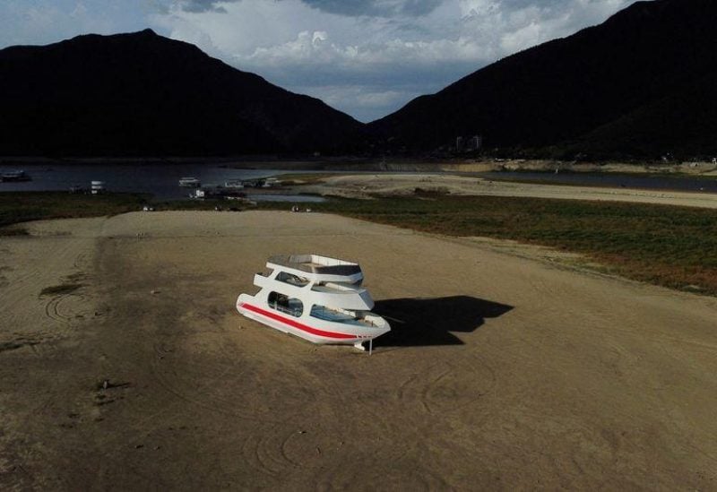 An aerial view shows a boat stranded on the La Boca dam due to a drought in northern Mexico, in Santiago, Mexico August 8, 2022. REUTERS/Daniel Becerril