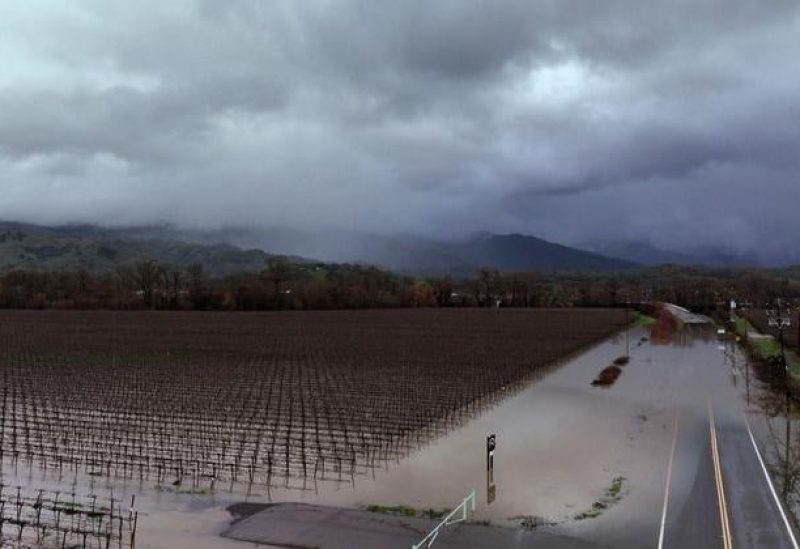 Dark storm clouds are seen above farmland and Highway 175 which were covered with floodwater in Hopland, California, U.S. January 14, 2023. REUTERS/Fred Greaves