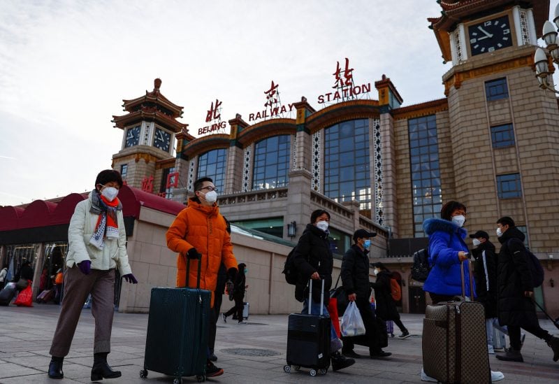 People walk outside Beijing Railway Station with their luggages as the annual Spring Festival travel rush starts, amid the coronavirus disease (COVID-19), ahead of the Chinese Lunar New Year, in Beijing, China January 7, 2023. REUTERS/Tingshu Wang