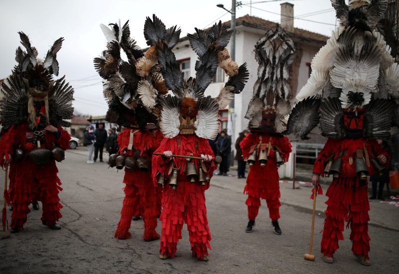 People wearing masks made of feathers participate in a winter festival in the village of Kosharevo, Bulgaria January 14, 2023. REUTERS/Stoyan Nenov